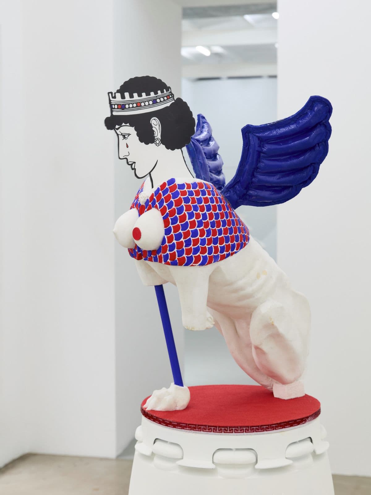 Rub Me the Right Way (resin), contemporary sphinx sculpture by Grigorios Ilaridis with reconstructed limbs, balloon-like wings and a flat portrait head.